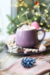 Cup of coffee with meringues and dessert on a plate, Christmas decor, hearts on the windowsill, home comfort concept, winter  
