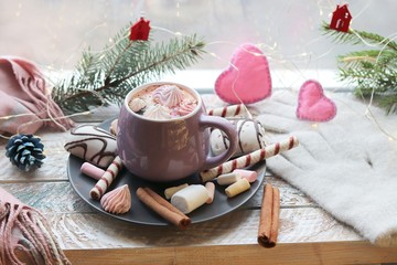 Cup of coffee with meringues and dessert on a plate, Christmas decor, hearts on the windowsill, home comfort concept, winter  