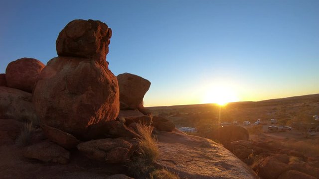 Amazing natural landscapes with pink colored twilight sky by Devils Marbles Conservation Reserve. Granite boulders symbol of Australia's outback, Northern Territory in Central Australia.