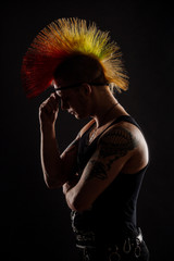 Portrait of punk rocker with Mohawk hairstyle on a black background.