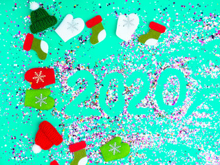 Colorful Sparkling holographic glitter confetti, toy hats, mittens, boots. Christmas Holidays...