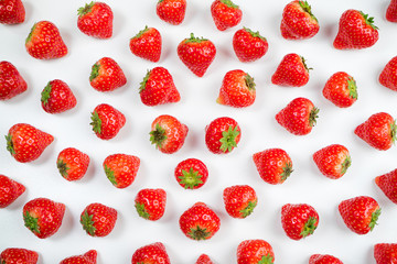 Strawberry on white background, top view. Berries pattern, flat lay. Pattern made of fresh strawberry on white. Creative food concept