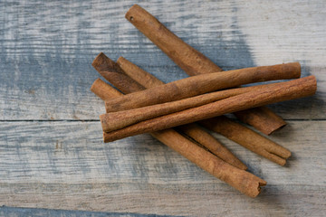 Cinnamon sticks on a wooden background