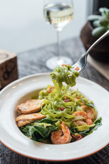 Green Tagliatelle Pasta with Spinach, Prawns and Chicken. Modern Cafe Lunch