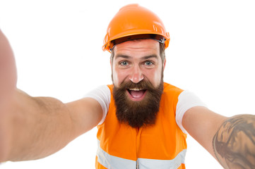 Building it better in concrete. Happy builder isolated on white. Building contractor with long beard. Bearded man smile in safety wear. Building and construction work. Building under renovation