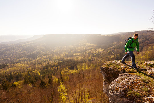Albstatt-Onstmettingen, Baden-W&cedil;rttemberg, Germany: A male hiker on the "Hangender Stein" cliff along the "Traufgang Zollernburg-Panorama" trail.