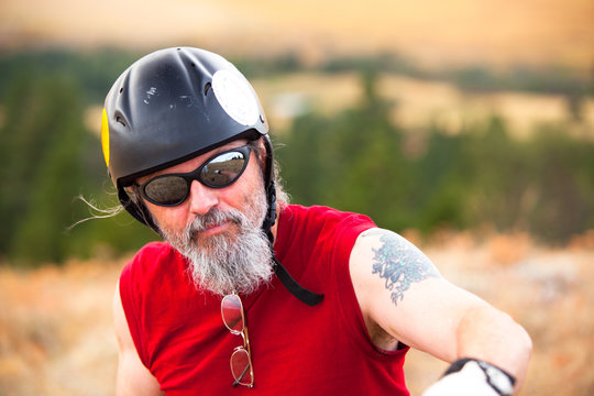 A man all geared up to fly from the top of Paradise Ridge during a father and son paragliding outing.