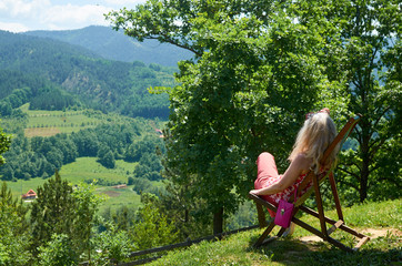 Blond woman enjoying a landscape