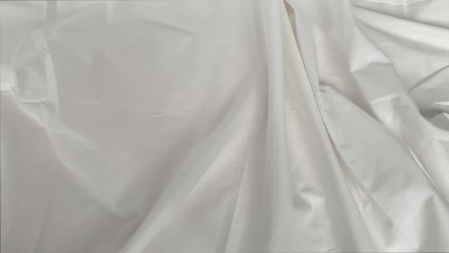 beautiful natural white cotton fabric draped with small folds, creases, texture, background, postcard form, copy space