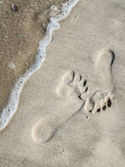 Fototapeta na wymiar Footprints in sand. Close up.