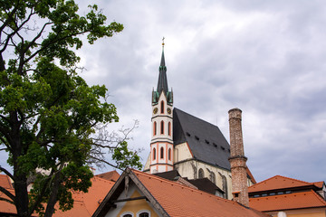 Fototapeta na wymiar View to St. Vitus Church and roofs of Old Town of Český Krumlov (Cesky Krumlov), Czech Republic