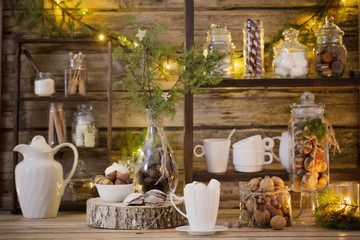 Christmas decoration cocoa bar with cookies and sweets on old wooden background in  natural rustic...