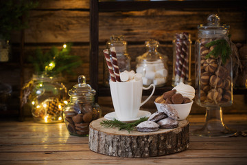 Christmas decoration cocoa bar with cookies and sweets on old wooden background in  natural rustic style. Winter cozy concept