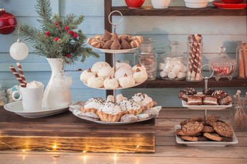 Christmas bar cacao decoration with cookies and sweets on blue wooden background in vintage style