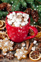 Red mug with hot chocolate and marshmallows and gingerbread cookies