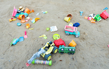 Fototapeta na wymiar children's toys scattered in the sandbox