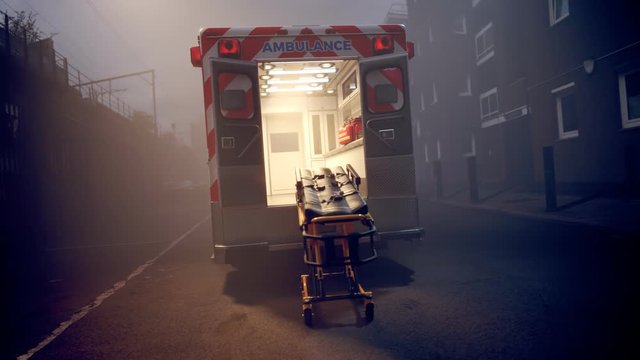 An empty ambulance with stretchers standing in the fog in the middle of the road