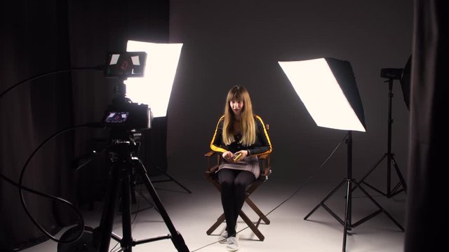 The girl record her blog at the studio. Working on a video project.backstage