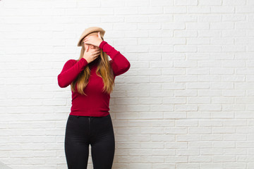 young artist woman covering face with both hands saying no to the camera! refusing pictures or...