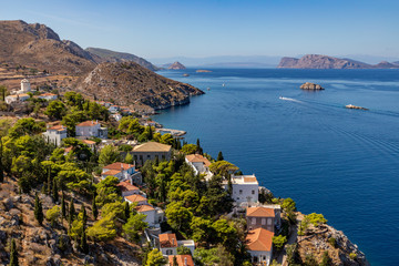 Naklejka premium Houses and buildings in the mountains with trees and vegetation in Hydra Island
