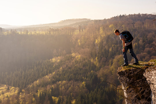 Albstatt-Onstmettingen, Baden-W&cedil;rttemberg, Germany: A male hiker on the "Hangender Stein" cliff along the "Traufgang Zollernburg-Panorama" trail.