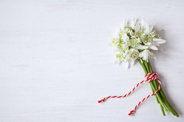 Bouquet of snowdrops on a wooden background for congratulations