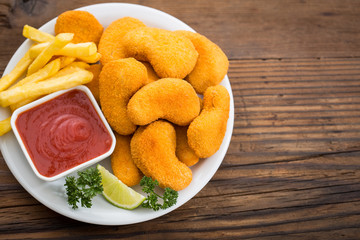 Chicken nuggets with ketchup on the plate