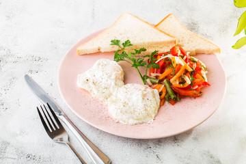Poached eggs with vegetable and sourdough toast isolated on white marble background. Homemade food. Tasty breakfast. Selective focus. Hotizontal photo.