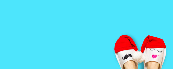 Sexy santa claus legs woman isolated over blue background