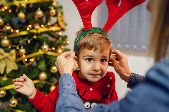 Woman And Her Son Or Grandson Mother Or Grandmother Sitting By The Christmas Tree Decorating At Home Family Single