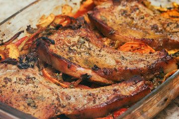 Baked pork meat in the oven. Vegetable side dish and spices. Traditional cuisine. Hot food. Pork tenderloin.