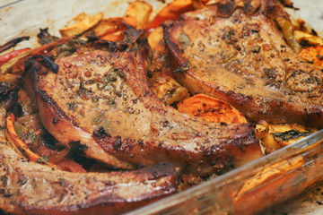 Baked pork meat in the oven. Vegetable side dish and spices. Traditional cuisine. Hot food. Pork tenderloin.