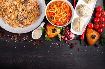 The concept of Eastern asian festive cuisine. Assorted Uzbek food set, pilaf, samsa, lagman, manta, shurpa restaurant concept, Uzbek food. Homemade Eastern arabic new year and Christmas dish from lamb