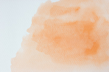Abstract orange watercolor on white background.