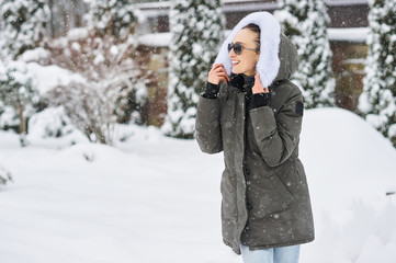 A portrait of beautiful caucasian girl in glases outdoor in snowy winter