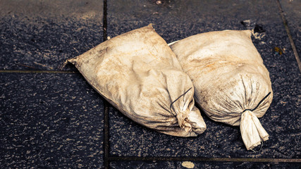 Two sand bags on ground