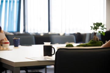 office table with black cup of coffee