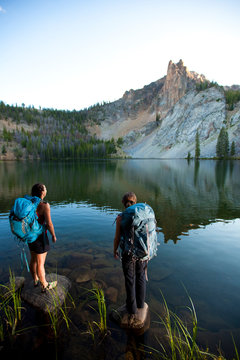 Two women take in the view at Hatchett Lake while on a backpacking trip in the White Cloud Mountains in Idaho.