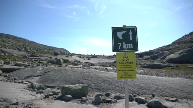 Signpost showing direction to Trolltunga, Norway. Skjeggedal, Norway - Jule 21, 2019: Signpost showing direction and distance to Trolltunga, or Troll Tongue