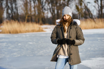 Portrait of happy young woman have a  fun at beautiful sunny winter day