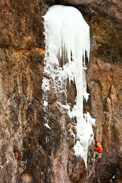 A man climbs Tasp M7 R WI5+, a hard-to-protect mixed line in Hyalite Canyon.