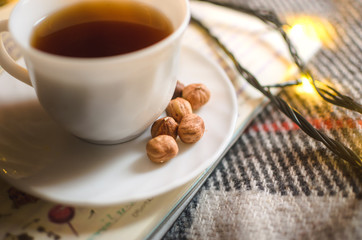 Hot black tea in an irony and warm atmosphere with a garland, Christmas atmosphere, morning lighting