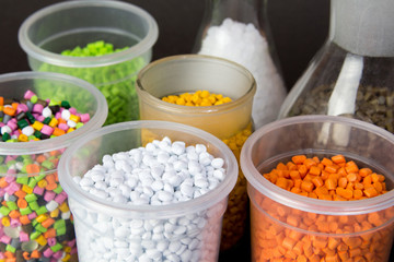 Plastic granules in a measuring container and test tubes in the laboratory. Plastic pellets. Plastic Raw material . BPA FREE