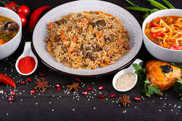 The concept of Eastern asian festive cuisine. Assorted Uzbek food set, pilaf, samsa, lagman, manta, shurpa restaurant concept, Uzbek food. Homemade Eastern arabic new year and Christmas dish from lamb