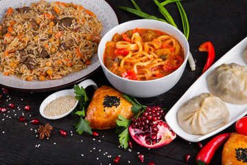 The concept of Eastern asian festive cuisine. Assorted Uzbek food set, pilaf, samsa, lagman, manta, shurpa restaurant concept, Uzbek food. Homemade Eastern arabic new year and Christmas dish from lamb