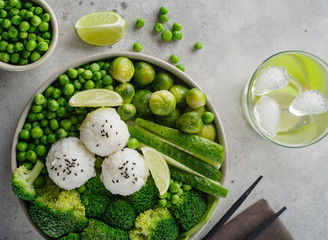 Green salad with rice and vegetables. Salad with lemon, cucumber, peas and broccoli.