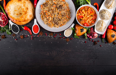 The concept of Eastern asian festive cuisine. Assorted Uzbek food set, pilaf, samsa, lagman, manta, shurpa restaurant concept, Uzbek food. Homemade Eastern arabic new year and Christmas dish from lamb