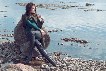 cosplay witch elf on the rocky shore by the sea