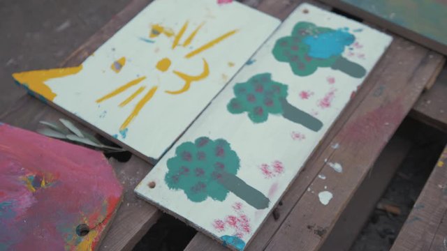 Childrens vibrant colorful paintings on wooden boards