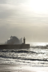 lighthouse with rough waves as background